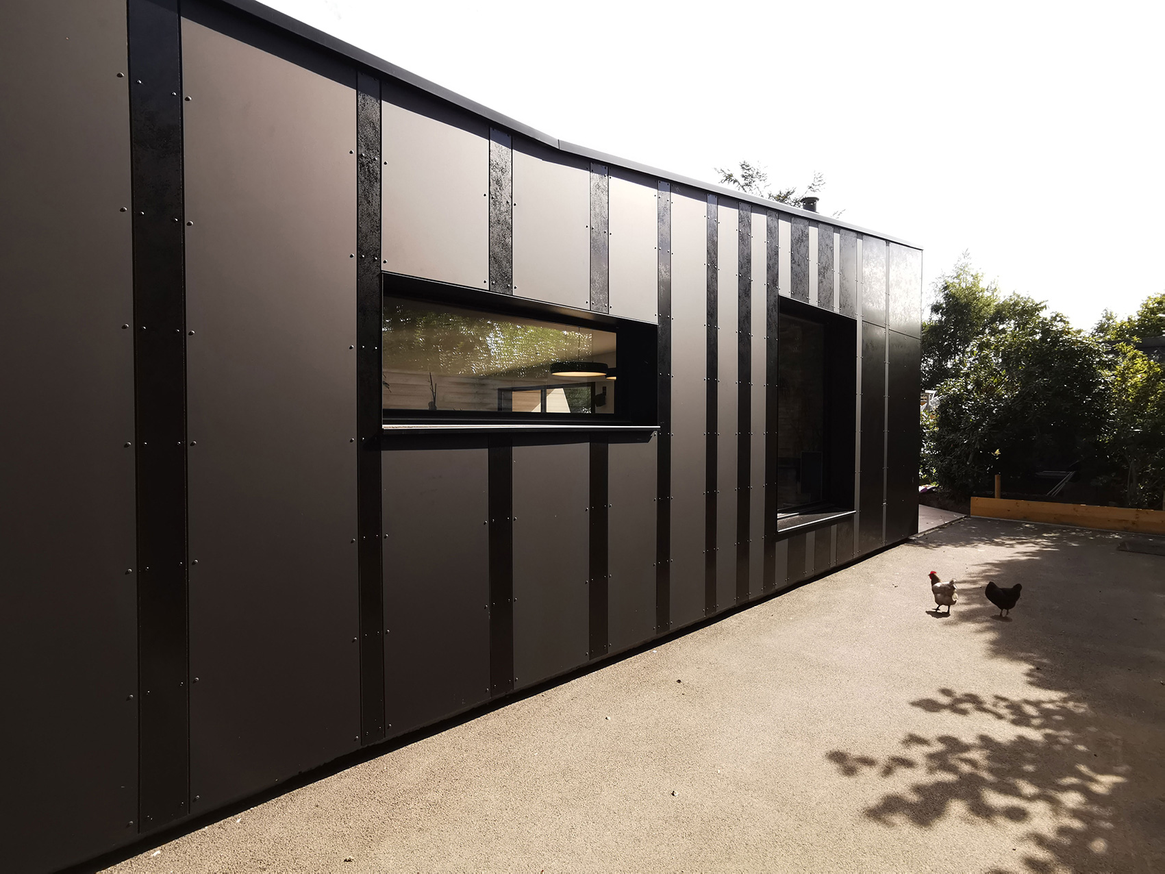 Bardage Trespa mat et brillant de l'extension d'une maison à Pont-à-Marcq